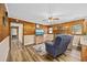 Comfortable living room featuring wood paneling, a fireplace, and cozy seating at 153 Busbee St., Conway, SC 29526