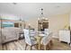 Open-concept dining and living area displaying wood flooring, stylish furniture, and natural light at 153 Busbee St., Conway, SC 29526