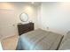 Neutral bedroom showcases a bed, dresser, round mirror, and two doors to other rooms at 1546 Villena Dr., Myrtle Beach, SC 29579