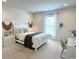 Bright bedroom boasts a cozy bed, desk, and ample natural light from the large window at 1546 Villena Dr., Myrtle Beach, SC 29579