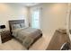 Cozy bedroom features shiplap wall, window, bed, and modern wooden nightstand and dresser at 1546 Villena Dr., Myrtle Beach, SC 29579