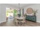 Bright dining area featuring stylish chandelier, sideboard, and outdoor access at 1546 Villena Dr., Myrtle Beach, SC 29579