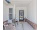 Inviting front porch featuring decorative chairs and decor, creating a cozy and welcoming entrance at 1546 Villena Dr., Myrtle Beach, SC 29579