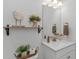 Stylish half bathroom with modern vanity, decorative shelving, and contemporary fixtures for guests at 1546 Villena Dr., Myrtle Beach, SC 29579