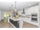 This bright, modern kitchen features pendant lights, stainless appliances and an island with seating at 1546 Villena Dr., Myrtle Beach, SC 29579