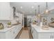 A bright kitchen features stainless appliances, pendant lighting and white cabinetry at 1546 Villena Dr., Myrtle Beach, SC 29579