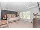 This main bedroom features a decorative tray ceiling, accent wall, and lots of natural light at 1546 Villena Dr., Myrtle Beach, SC 29579