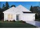Charming single-story home with white siding, stone accents, and a well-manicured lawn at 1579 Regal Fern Way, Longs, SC 29568