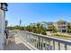 Balcony view overlooking charming coastal homes with lush landscaping and street access at 1611B S Ocean Blvd., Surfside Beach, SC 29575