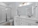 Bright bathroom with double vanity, updated fixtures, and glass shower door at 1611B S Ocean Blvd., Surfside Beach, SC 29575