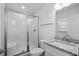 Bright bathroom featuring a glass enclosed shower, white fixtures, and a granite countertop at 1611B S Ocean Blvd., Surfside Beach, SC 29575