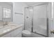 This bathroom is bright and airy with a glass enclosed shower and a white sink at 1611B S Ocean Blvd., Surfside Beach, SC 29575