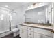 This bathroom features dual sinks, granite countertops, and a glass enclosed shower at 1611B S Ocean Blvd., Surfside Beach, SC 29575