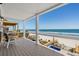 Beautiful covered porch with views of the ocean, pools, and sandy beach at 1611B S Ocean Blvd., Surfside Beach, SC 29575