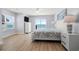 This well-lit bedroom features a large bed, dresser, and a view of the ocean at 1611B S Ocean Blvd., Surfside Beach, SC 29575
