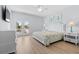Bright bedroom with a queen bed, private balcony access, and tasteful decor at 1611B S Ocean Blvd., Surfside Beach, SC 29575
