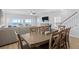 An open dining area showcasing a wooden table, seating for eight, and ocean views at 1611B S Ocean Blvd., Surfside Beach, SC 29575