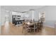 Dining area with modern lighting and a large table, adjacent to a well-equipped kitchen at 1611B S Ocean Blvd., Surfside Beach, SC 29575