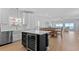 Open concept kitchen with stainless steel appliances and an island with a wine cooler and breakfast bar at 1611B S Ocean Blvd., Surfside Beach, SC 29575