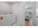 This well-lit laundry room includes side-by-side washer and dryer at 1611B S Ocean Blvd., Surfside Beach, SC 29575