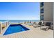An inviting pool with lounge chairs, perfect for relaxation and enjoying the ocean view at 1611B S Ocean Blvd., Surfside Beach, SC 29575