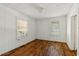 Bright bedroom with wood floors, two windows, and white paneled walls at 1800 9Th Ave., Conway, SC 29527