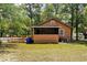 Exterior view of a single-story home featuring a ramp, trees, and a lawn at 1800 9Th Ave., Conway, SC 29527