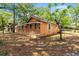 Exterior view of a cozy single-story home with a ramp, and mature trees, surrounded by natural foliage at 1800 9Th Ave., Conway, SC 29527