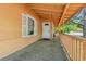 Wide-angle view of the home's expansive front porch with wood railing and a white front door at 1800 9Th Ave., Conway, SC 29527