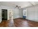 Spacious living room features wood floors, ceiling fan, and access to other rooms at 1800 9Th Ave., Conway, SC 29527
