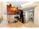 Modern kitchen featuring granite countertops, wood cabinets, and stainless appliances at 215 77Th Ave. N # 807, Myrtle Beach, SC 29572