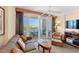 A cozy living area with large sliding doors opening onto a balcony at 215 77Th Ave. N # 807, Myrtle Beach, SC 29572