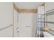Bright bathroom featuring a shower with a blue and white striped curtain and built-in shelving for storage at 223 Maison Dr. # C7, Myrtle Beach, SC 29572
