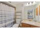 Well-lit bathroom with updated vanity, shower curtain and convenient shelving at 223 Maison Dr. # C7, Myrtle Beach, SC 29572