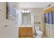 Cozy bathroom with wood vanity, decorative fixtures and a blue and yellow shower curtain at 223 Maison Dr. # C7, Myrtle Beach, SC 29572