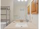 Bathroom vanity featuring a speckled countertop and a large mirror, with convenient shelving and cabinet space at 223 Maison Dr. # C7, Myrtle Beach, SC 29572
