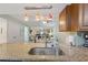 Close up on the kitchen sink and granite countertops, with a view through to the open plan living area at 223 Maison Dr. # C7, Myrtle Beach, SC 29572