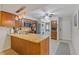 Modern kitchen featuring granite counters, stainless appliances, laundry area, and warm wooden cabinets at 223 Maison Dr. # C7, Myrtle Beach, SC 29572