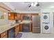 Contemporary kitchen featuring stainless appliances, granite countertops, wood cabinets and adjacent laundry at 223 Maison Dr. # C7, Myrtle Beach, SC 29572