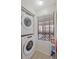 Convenient laundry area featuring stacked washer and dryer, storage, and window with natural light at 223 Maison Dr. # C7, Myrtle Beach, SC 29572