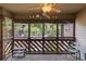Inviting screened-in porch with outdoor seating, a ceiling fan, and views of lush greenery and palm trees at 223 Maison Dr. # C7, Myrtle Beach, SC 29572