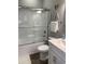 Bathroom features a glass shower, white vanity with a sink, brushed nickel accents, and wood-look floors at 223 S 9Th Ave. S, North Myrtle Beach, SC 29582