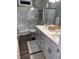 Bright bathroom featuring a glass shower, double sink with white cabinets, and wood look floors at 223 S 9Th Ave. S, North Myrtle Beach, SC 29582