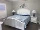 Comfortable bedroom featuring a white bed, striped bedding, and coastal-themed wall decor at 223 S 9Th Ave. S, North Myrtle Beach, SC 29582