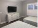 Comfortable bedroom features two twin beds, a dresser with TV, and shuttered windows at 223 S 9Th Ave. S, North Myrtle Beach, SC 29582