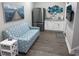 Living room with stainless steel refrigerator, mini bar, mounted television, and star patterned couch at 223 S 9Th Ave. S, North Myrtle Beach, SC 29582
