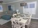 Living room and dining area with a table set for six, decorative chandelier, and comfortable sectional at 223 S 9Th Ave. S, North Myrtle Beach, SC 29582