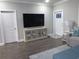 Living room featuring modern console, large television, stylish lamp, and interior door at 223 S 9Th Ave. S, North Myrtle Beach, SC 29582