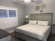 Serene main bedroom features a queen-sized bed, shuttered window, and decorative wall art at 223 S 9Th Ave. S, North Myrtle Beach, SC 29582