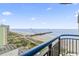 Balcony with a view of the beach, showcasing nearby buildings and the pier against a beautiful sky at 2300 N Ocean Blvd. # 1430, Myrtle Beach, SC 29577